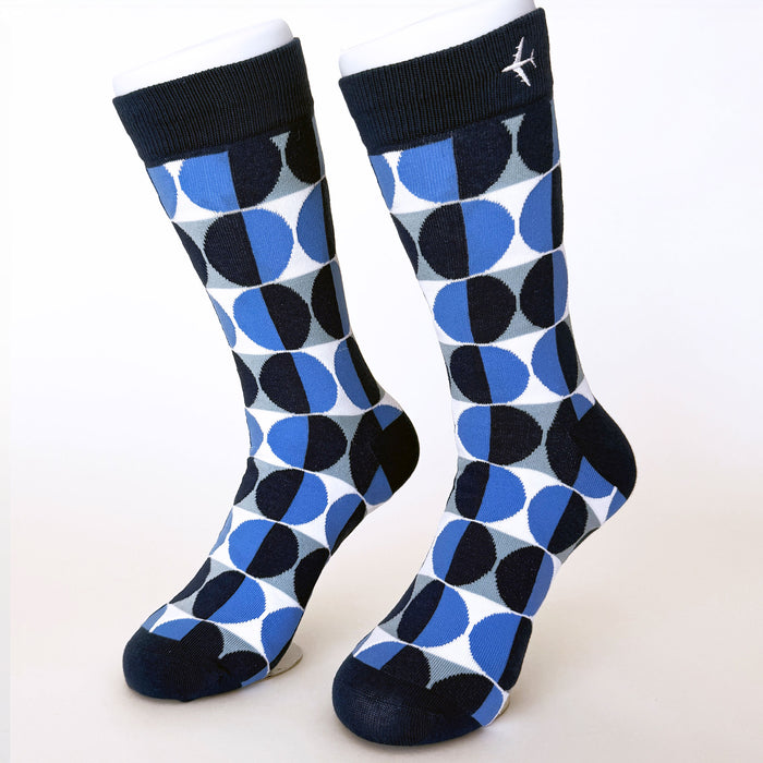 Pair of blue and black patterned socks on a white background