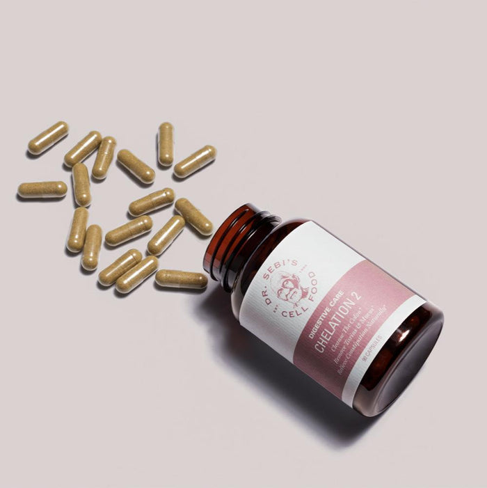 Dr. Sebi's Greenative 2 supplement bottle with golden herbal capsules arranged on neutral background.