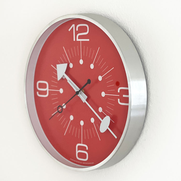 Red wall clock with silver frame on a white background