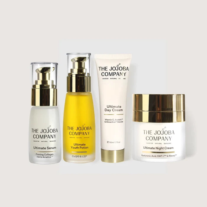 Four skincare products from The Jojoba Company on a light gray background