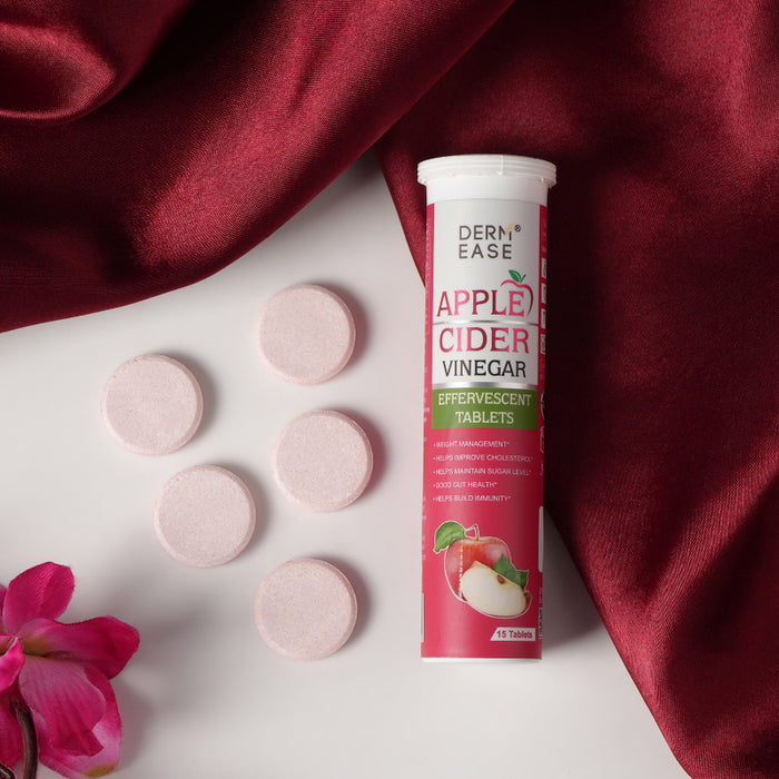Derm Ease Apple Cider Vinegar effervescent tablets on a white surface with red fabric and pink flower.