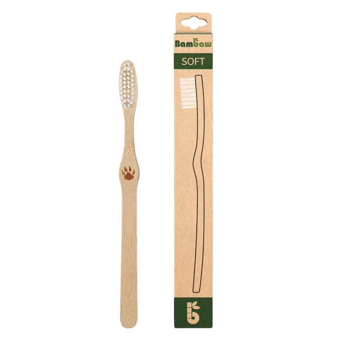 Bamboo toothbrush with soft bristles shown beside its cardboard packaging labeled SOFT