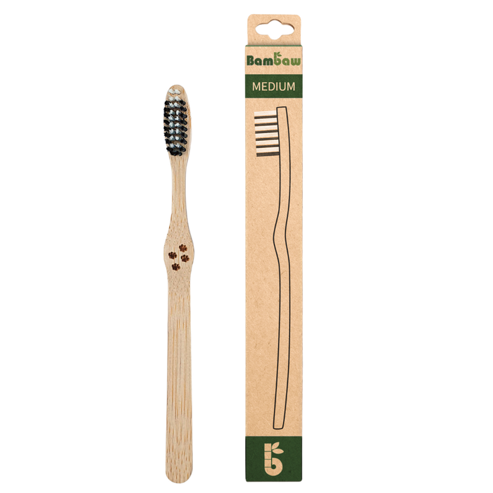 Bamboo toothbrush with medium bristles shown beside its packaging labeled MEDIUM