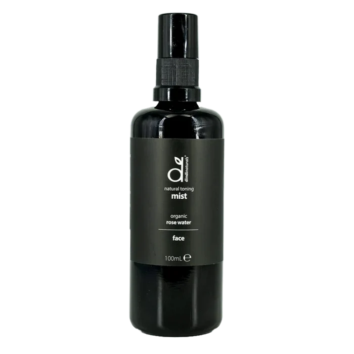 Black bottle of organic rose water mist on a white background