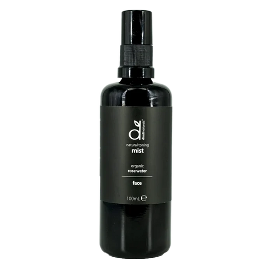 Black bottle of organic rose water mist on a white background