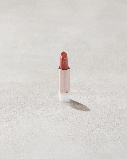 An open Fenty Icon refillable matte lipstick in the high-pigment shade, Ballin' Babe.
