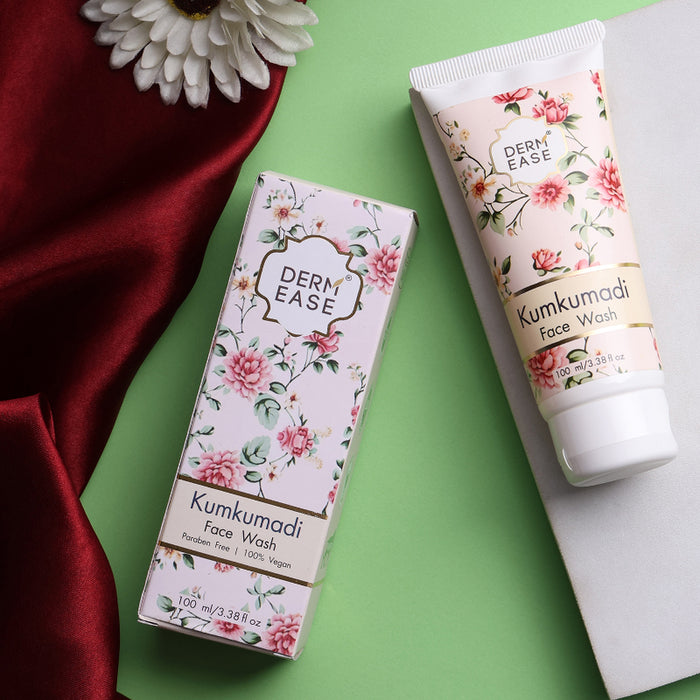 Derm Ease Kumkumadi Face Wash packaging on a green background with a white flower.