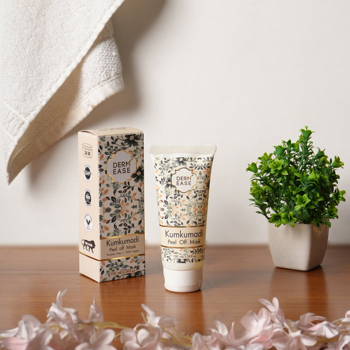 Derm Ease Kumkumadi Peel Off Mask with packaging and a plant on a wooden surface.