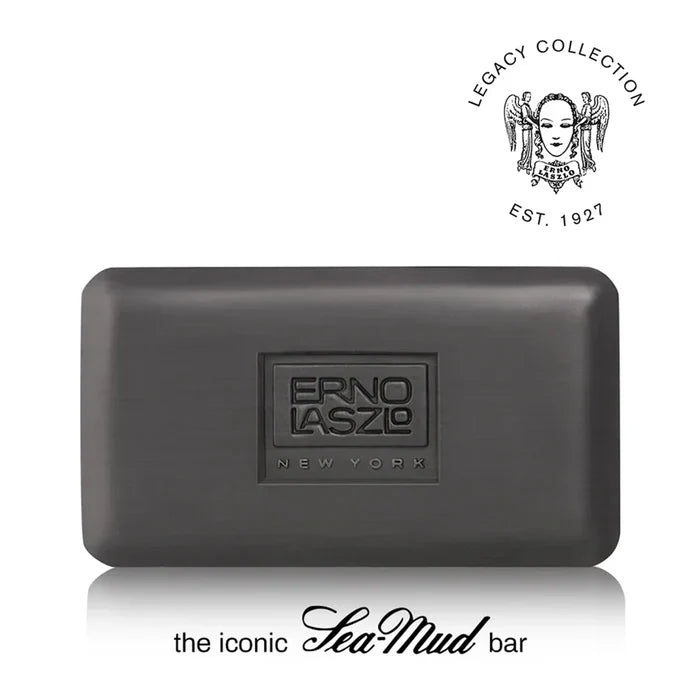 A dark gray rectangular bar of soap with a brushed metal finish, featuring an embossed logo that reads 'ERNO LASZO NEW YORK'. The image includes a 'Legacy Collection Est.