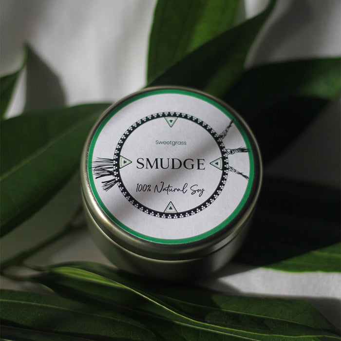 The 4oz travel tin in Smudge from LODGE Soy Candles is a light and calming scent made with sweetgrass.