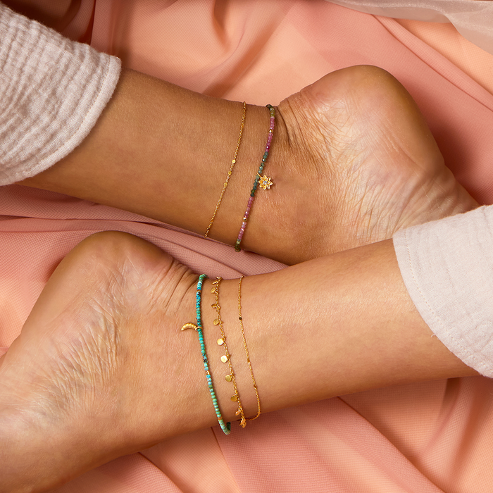 A beautiful arrangement of anklets, including the Walk with Joy Coin Chain Anklet, known for its shimmering design. This spiritual talisman enhances meditation and symbolizes protection, making it a perfect charm for those who appreciate zodiac-inspired and meaningful jewelry.